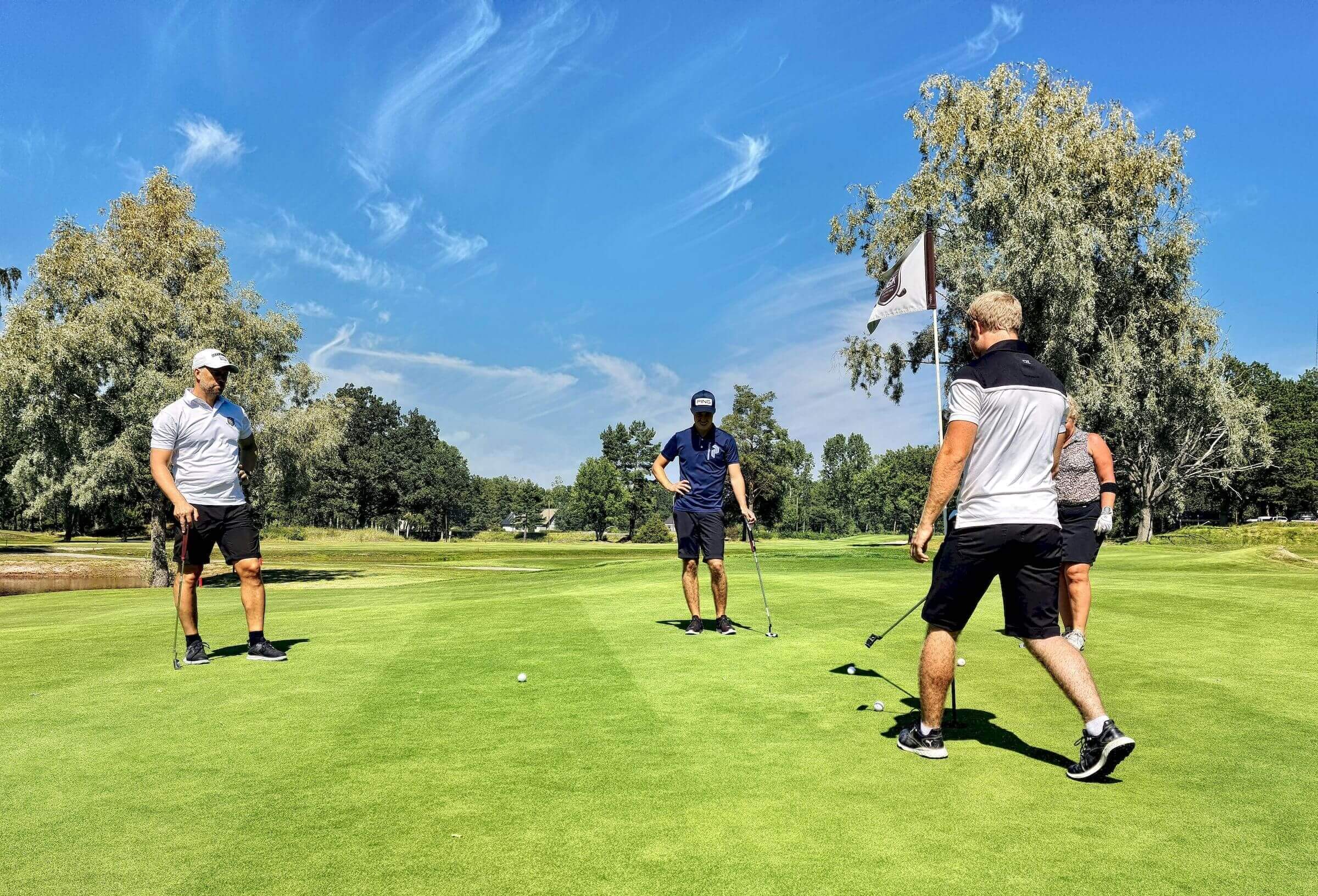 golfers on putting green