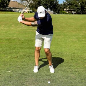 man swinging golf club