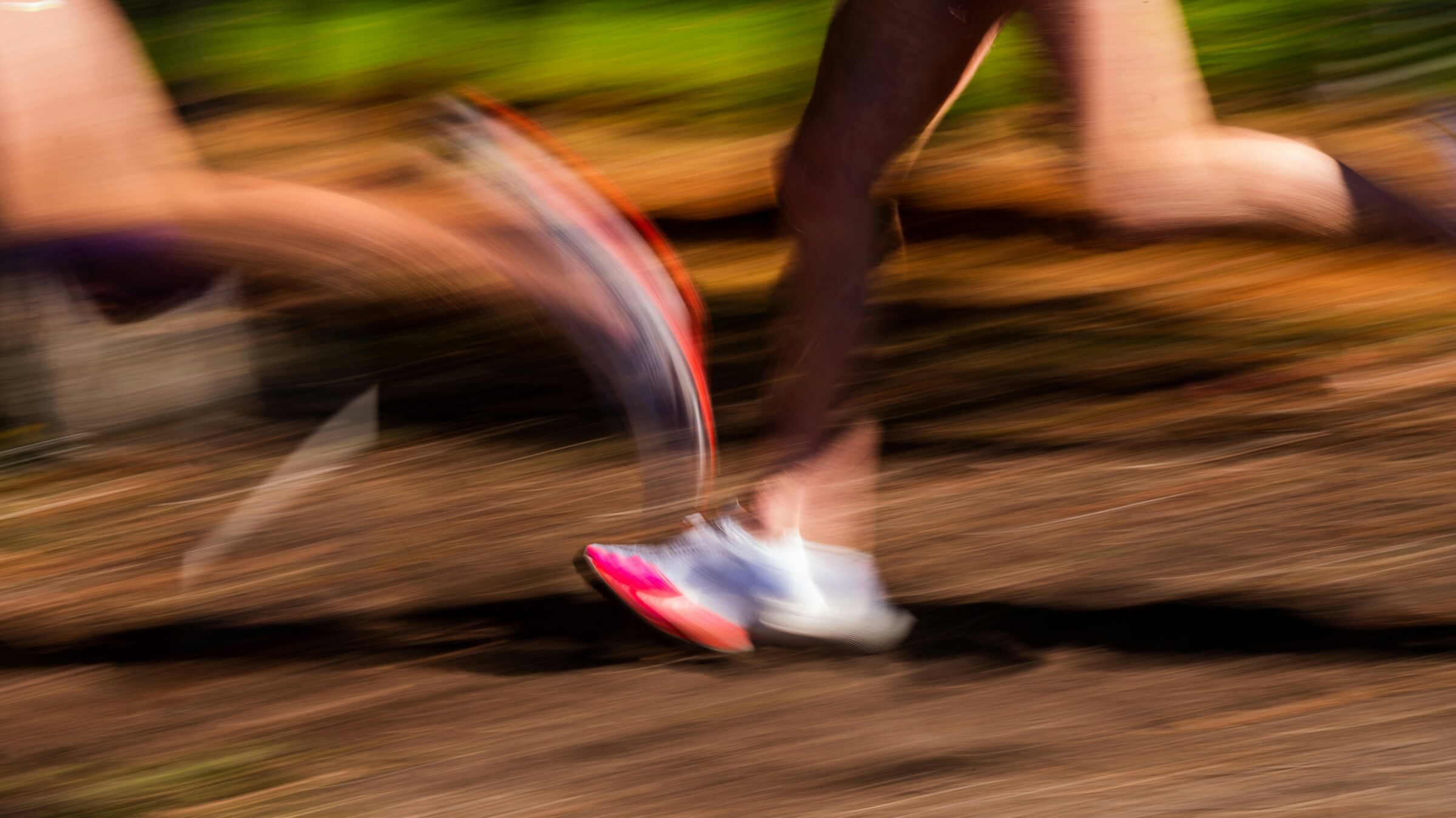 Running cross country picture shows runners leg with blurred photo