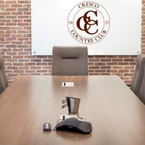 Empty board room with Cresco Country Club logo on wall